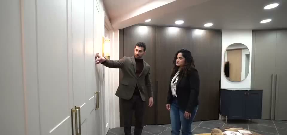 An Arch KBB designer showing a client cabinetry inside the King Street showroom